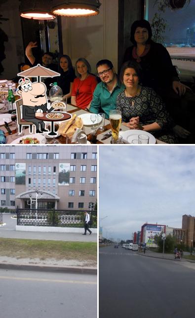 Изображение, на котором видны внешнее оформление и столики в Тбилисо