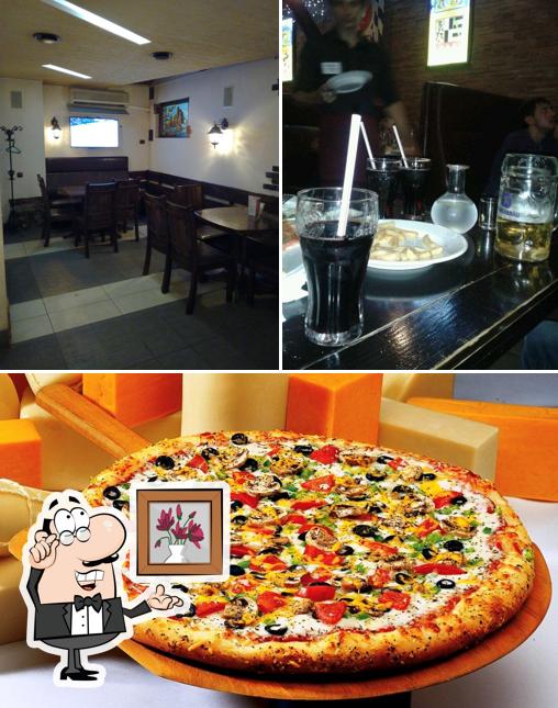 Это фото, где изображены внутреннее оформление и пицца в Мир пиццы